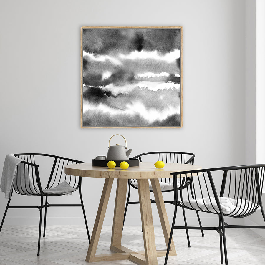 Abstract black and white canvas art print with watercolour washes resembling clouds in a modern, minimalist dining room. 