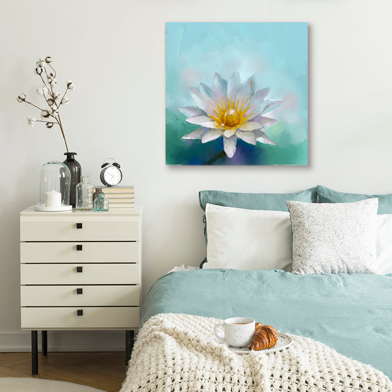 Wall art print featuring a white lotus flower contrasting against vibrant aquamarine water in a white and blue bedroom.