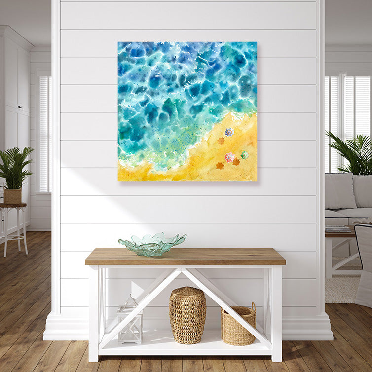 Beach art print of an aqua-blue sea, a golden sandy beach, and colourful beach umbrellas, in a beachy style interior.